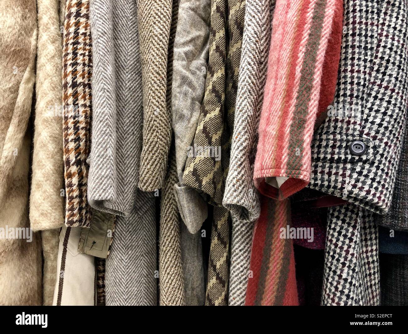 Different woolen vintage coats hanging in a row Stock Photo Alamy