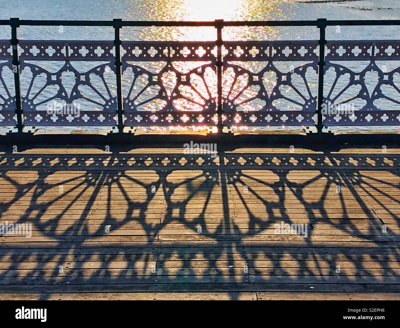 Shadows of pier railings on Penarth pier, Wales, afternoon, November. Stock Photo
