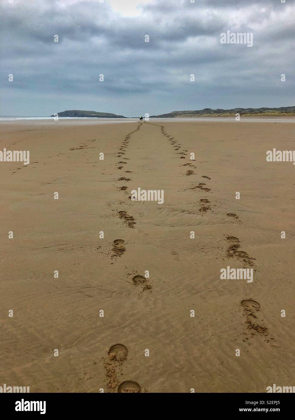 Hoof prints in the sand from two distant riders cantering across Llangennith beach, Gower, Wales, November. - Smartphone Captured Stock Image
