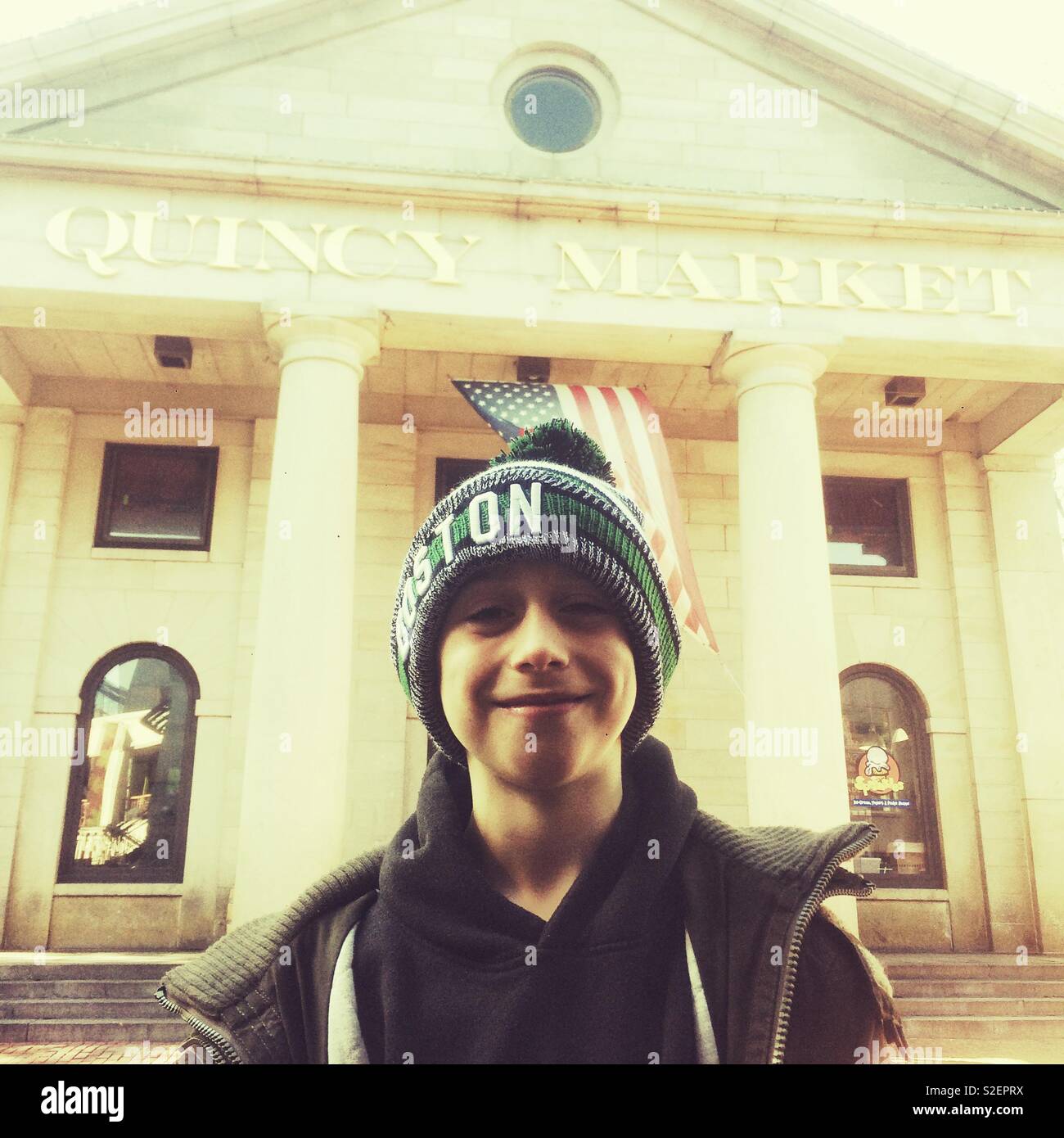 Nine year old boy outside Quincy Market, Boston, Massachusetts, United States of America. - Smartphone Captured Stock Image
