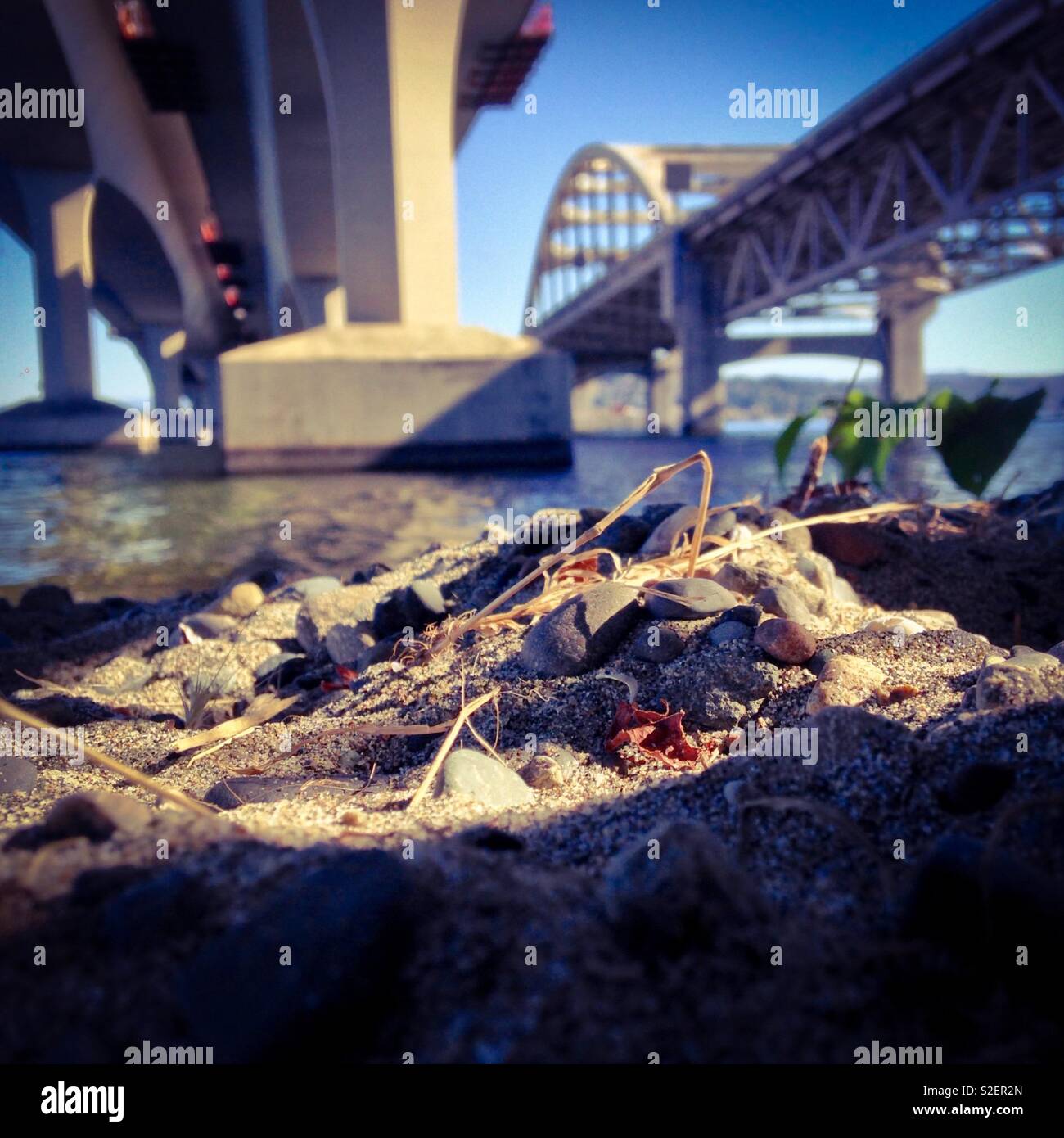 Sand and rocks under the I-90 bridge at Lake Washington, Seattle - Smartphone Captured Stock Image