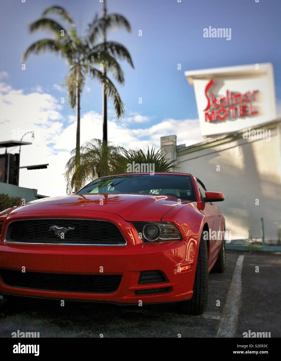 Muscle car Ford Mustang parked at a motel in sunny Los Angeles Stock