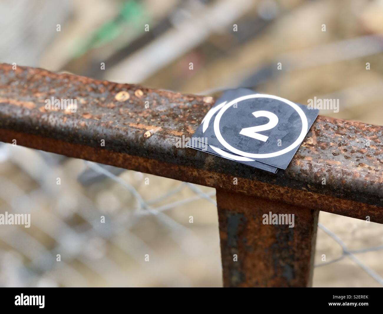 Stickers with the number two laying on a rusty railing Stock Photo - Alamy