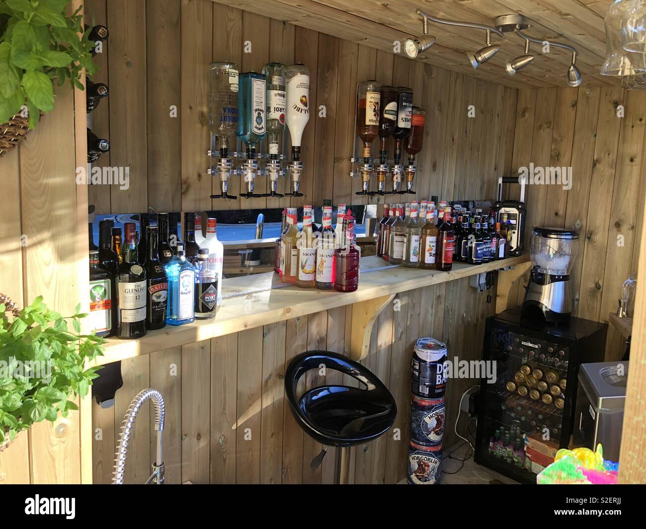 Well stocked bar with wooden interior Stock Photo