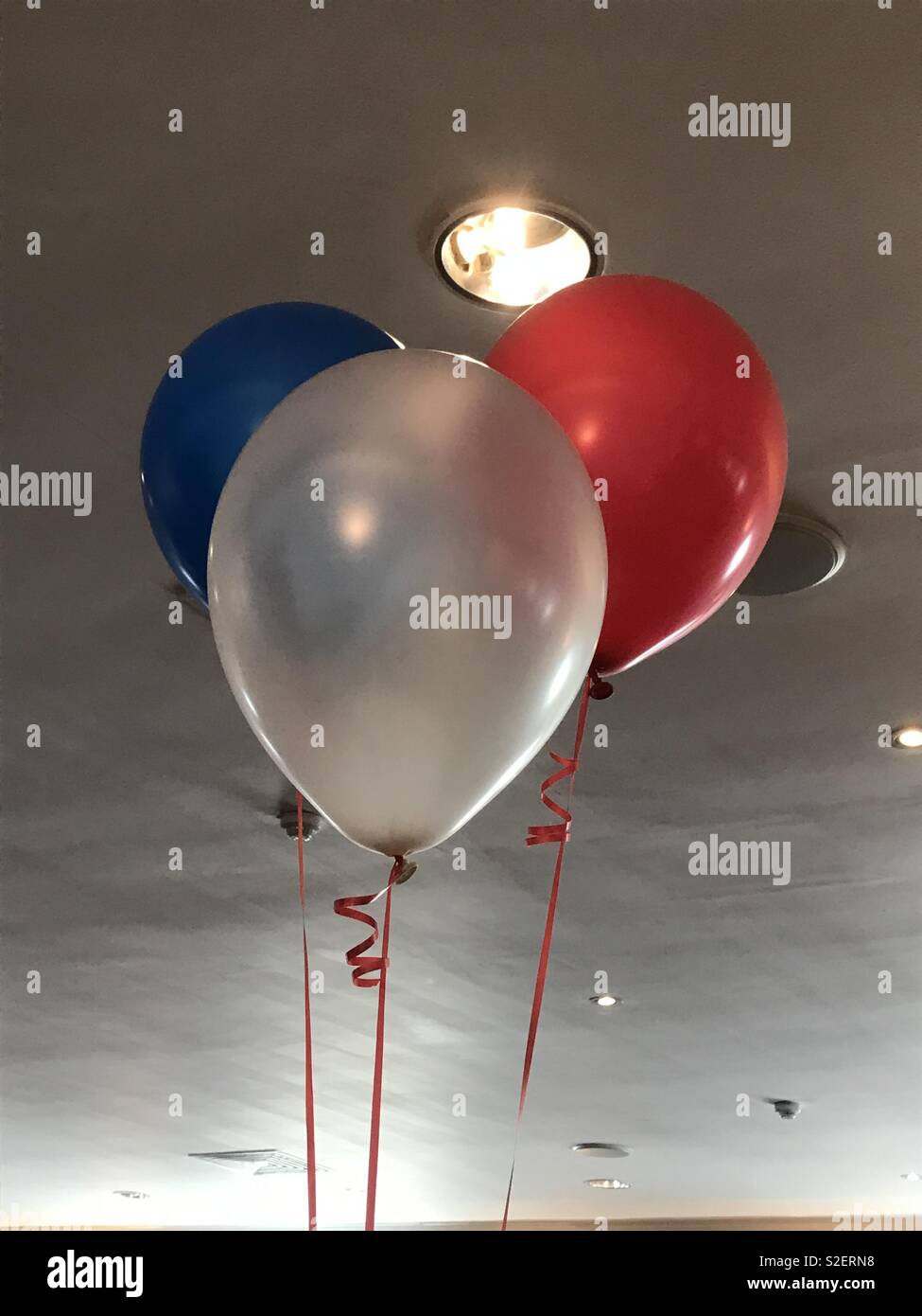 Balloons in the colours of the French flag at the Dragon Hotel, Swansea, Beaujolais Day 2018. - Smartphone Captured Stock Image