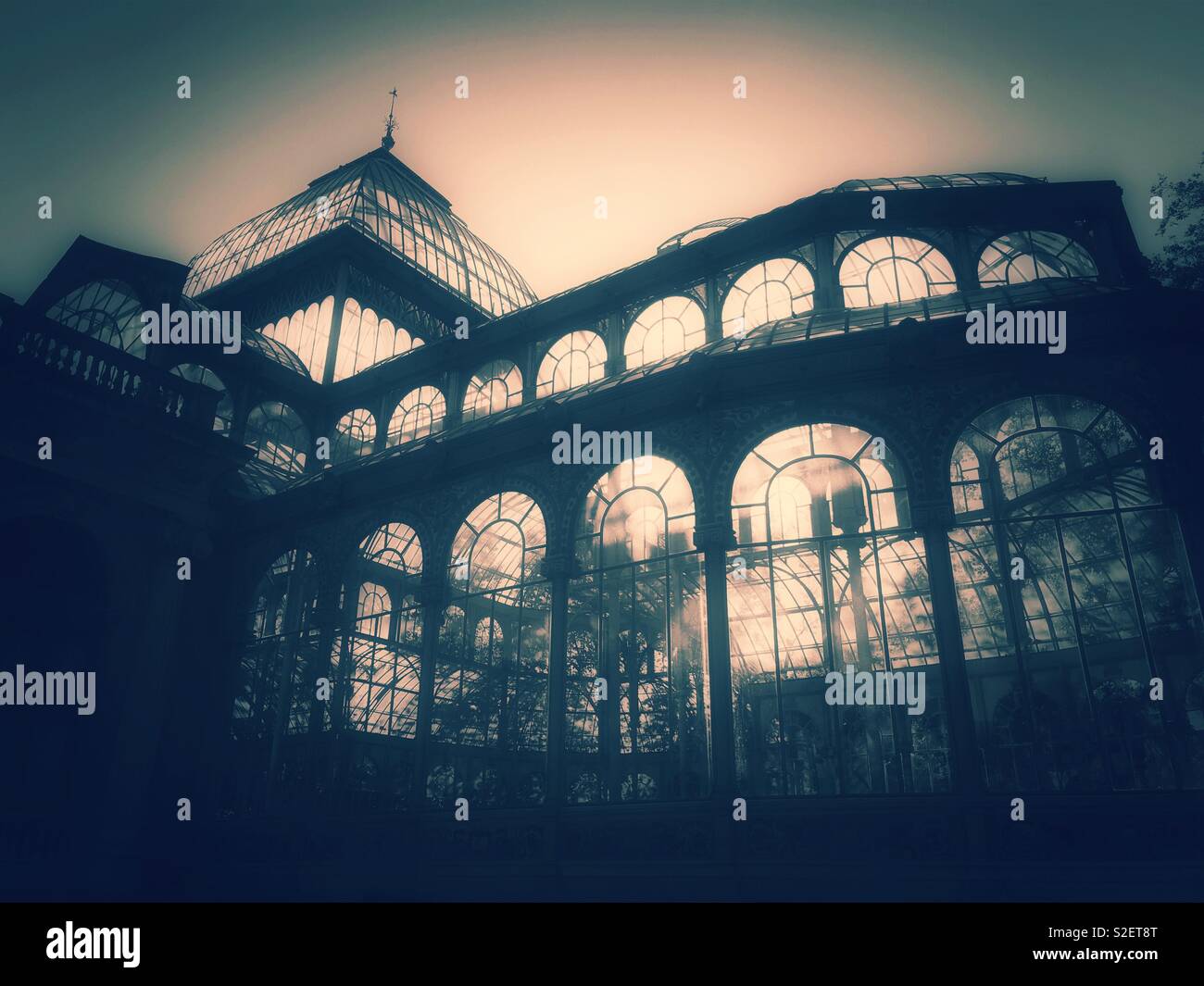 A moody, atmospheric & possibly ghostly image of the Palacio de Cristal (Crystal Palace) in Buen Retiro Park, Madrid, Spain. A famous tourist destination which has many uses. Photo © COLIN HOSKINS. - Smartphone Captured Stock Image