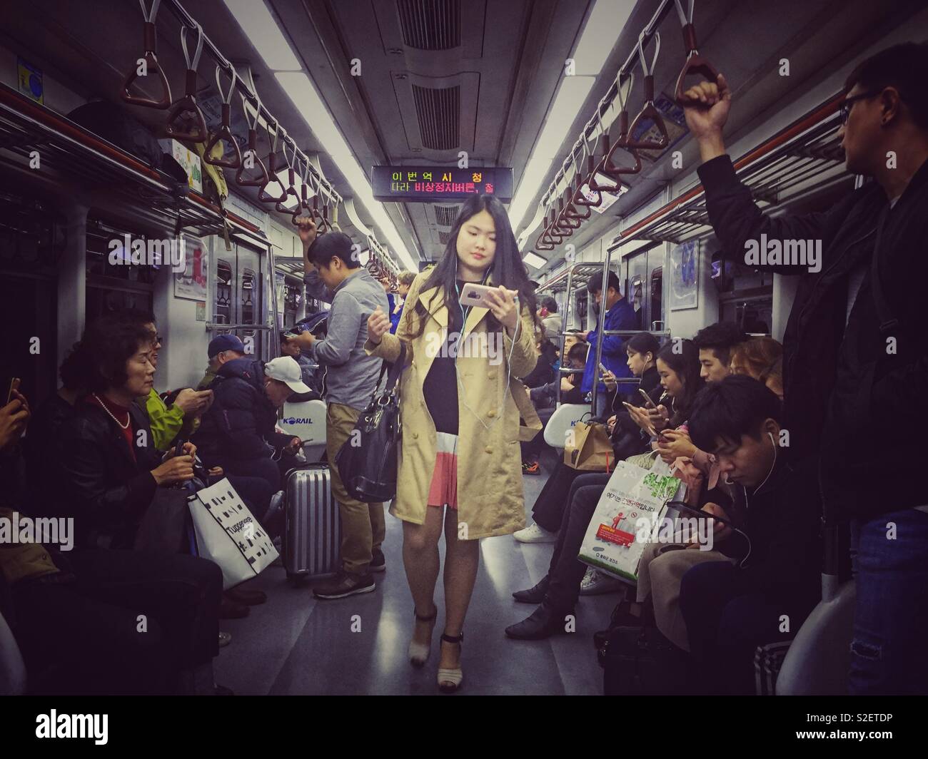 Passengers travel on a Seoul metro train. - Smartphone Captured Stock Image