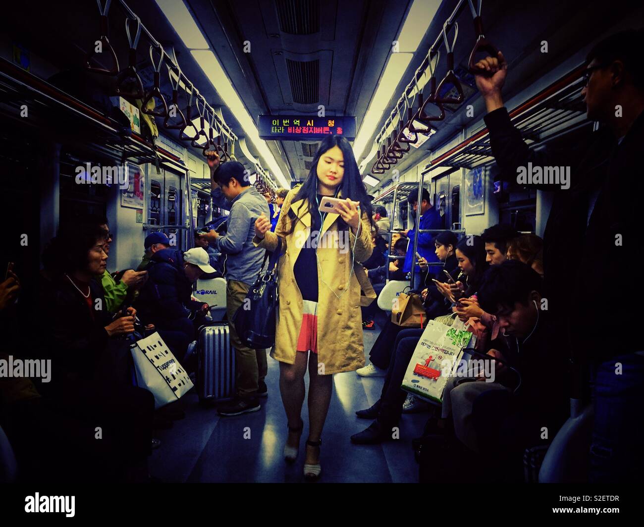 Passengers travel on a Seoul metro train. - Smartphone Captured Stock Image