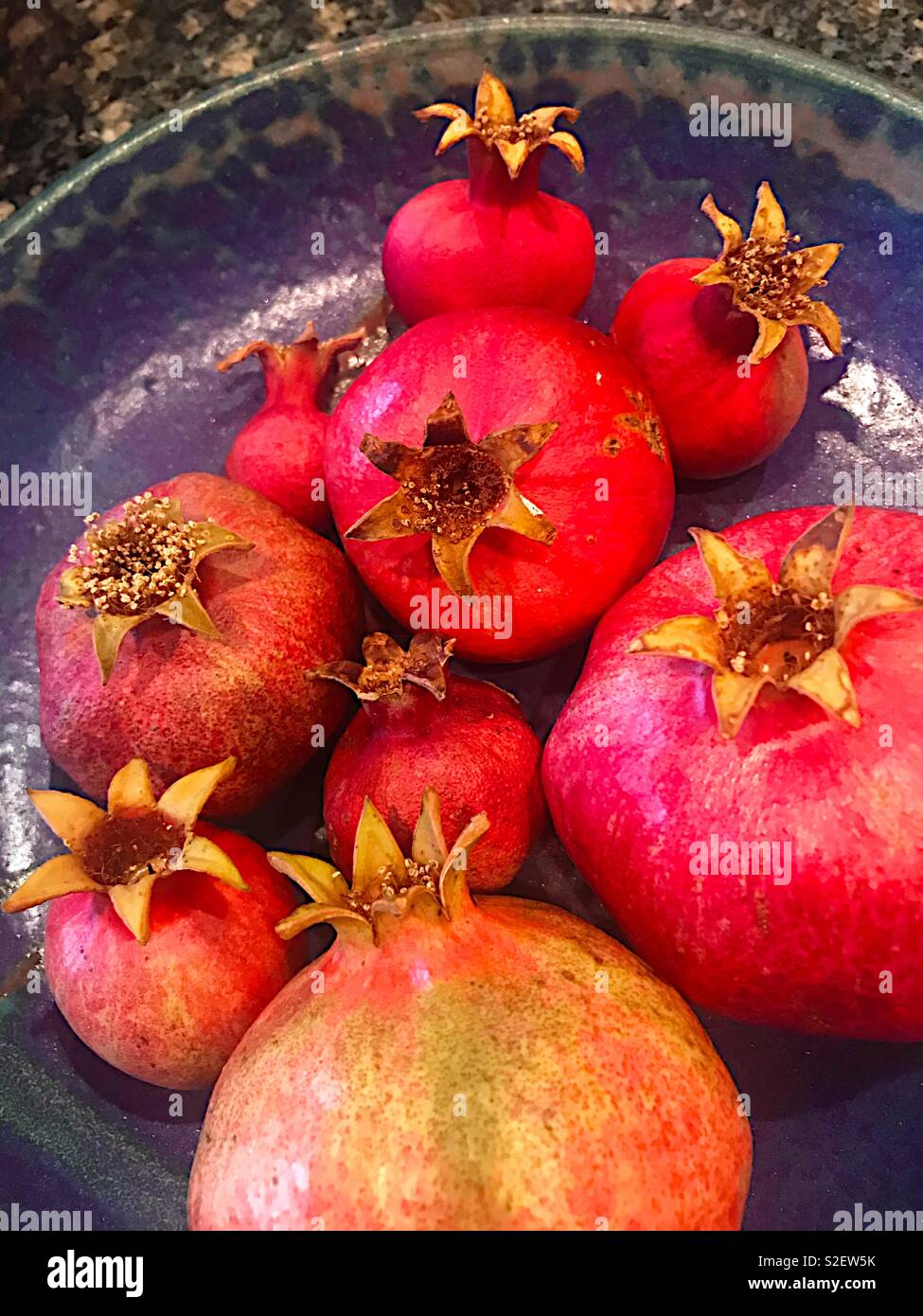 Pomegranates in a blue, ceramic bowl - Smartphone Captured Stock Image