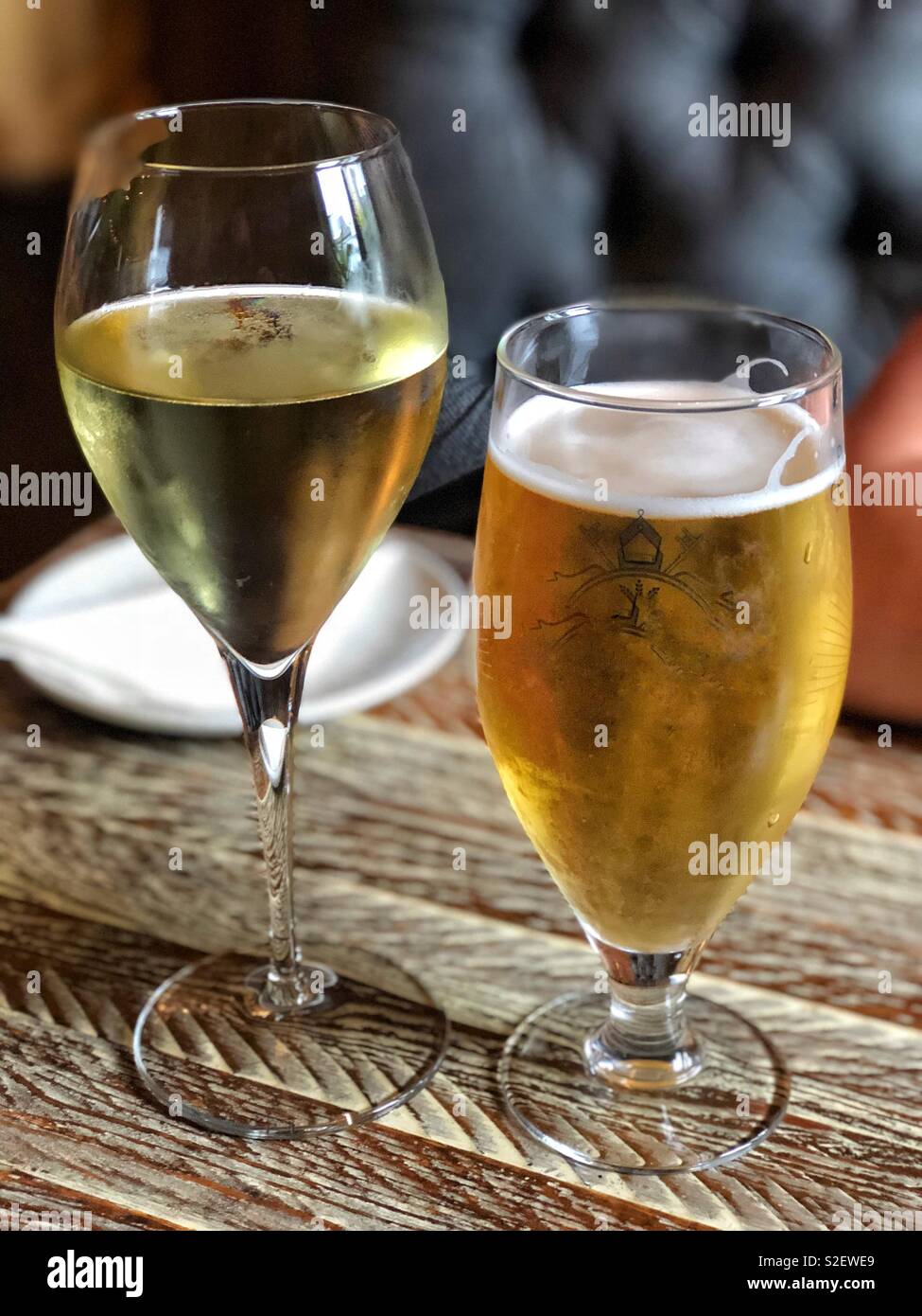 Drinks. A glass of white wine and a pint of lager. Stock Photo