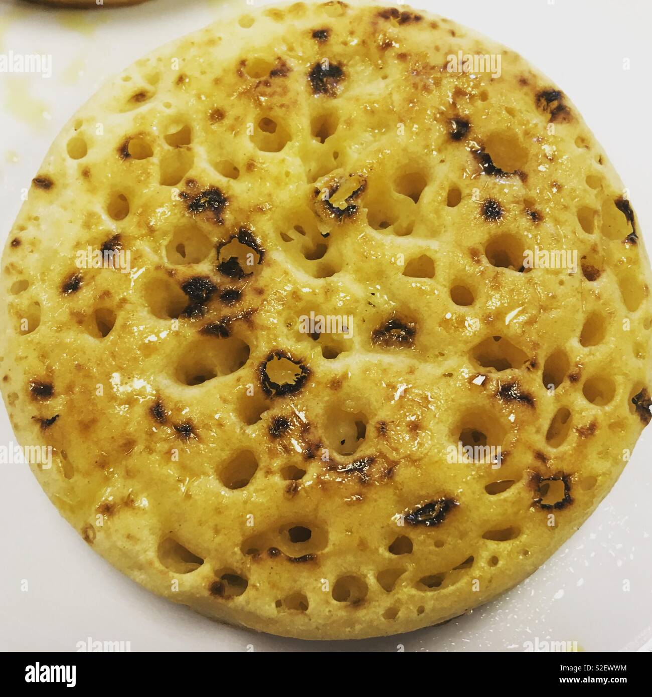 Hot buttered crumpet Stock Photo