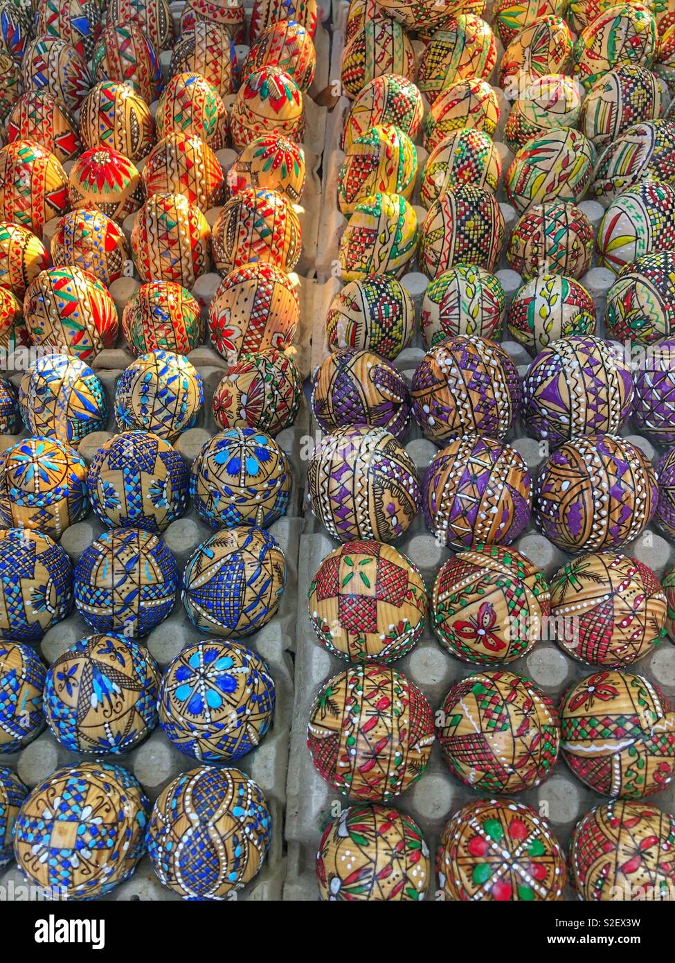 Rows of hand painted wooden eggs. - Smartphone Captured Stock Image