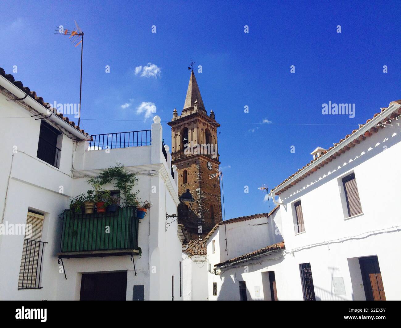 Spanish village with central church peeping through houses in Alájar Andalucia Spain Stock Photo
