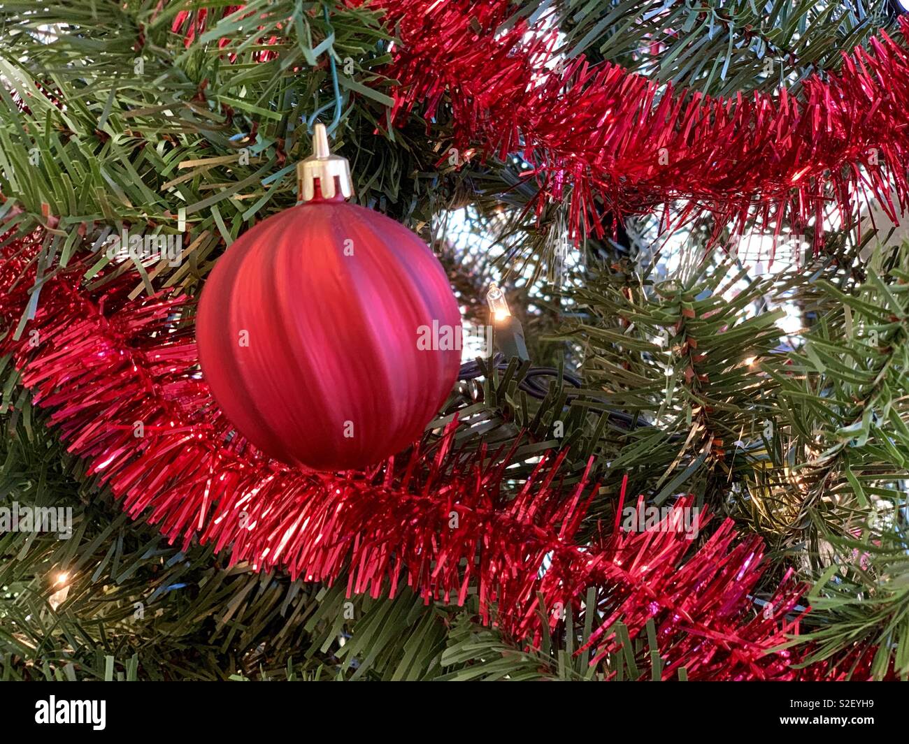 Simple red ornament and garland on Christmas tree Stock Photo Alamy