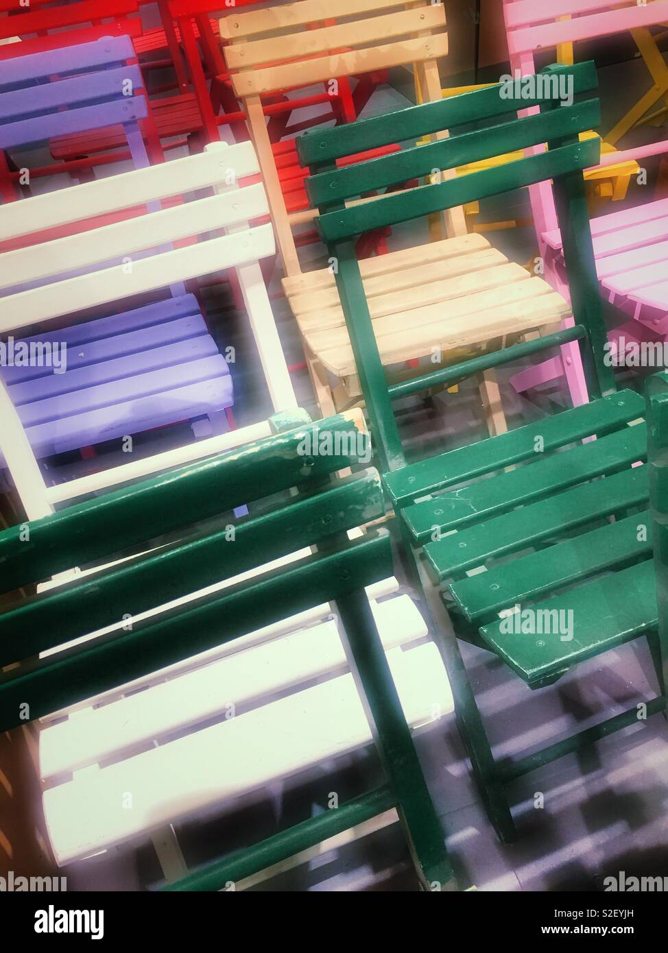 A group of multicolored wooden chairs, USA - Smartphone Captured Stock Image