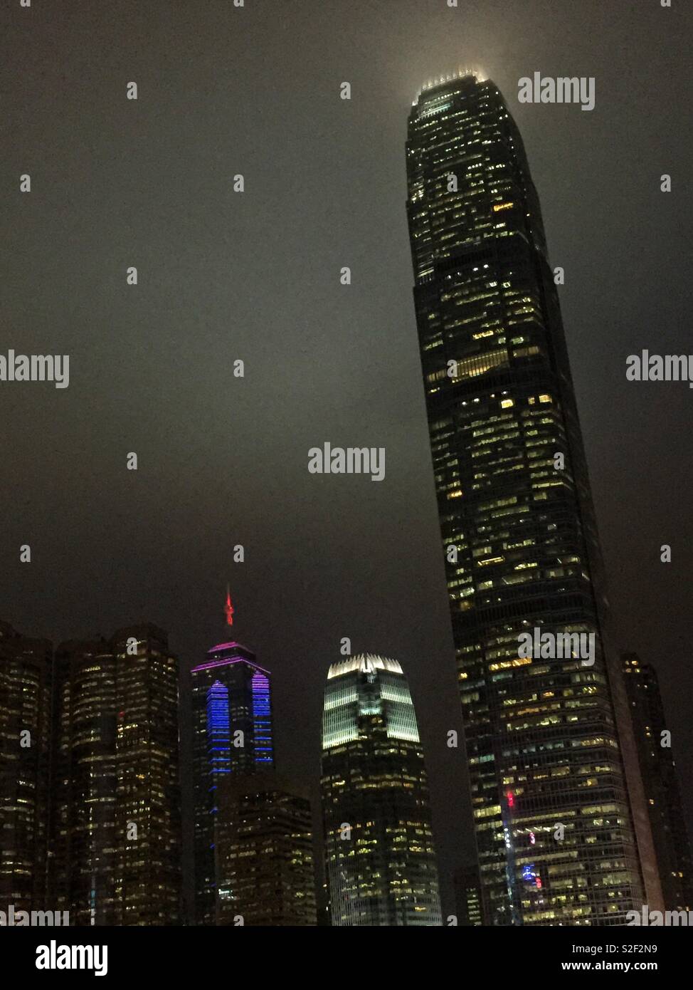 Hong Kong Island commercial skyscapers at night: (l to r) Exchange Square, The Center, 1ifc, and 2ifc, Hong Kong's second tallest - Smartphone Captured Stock Image