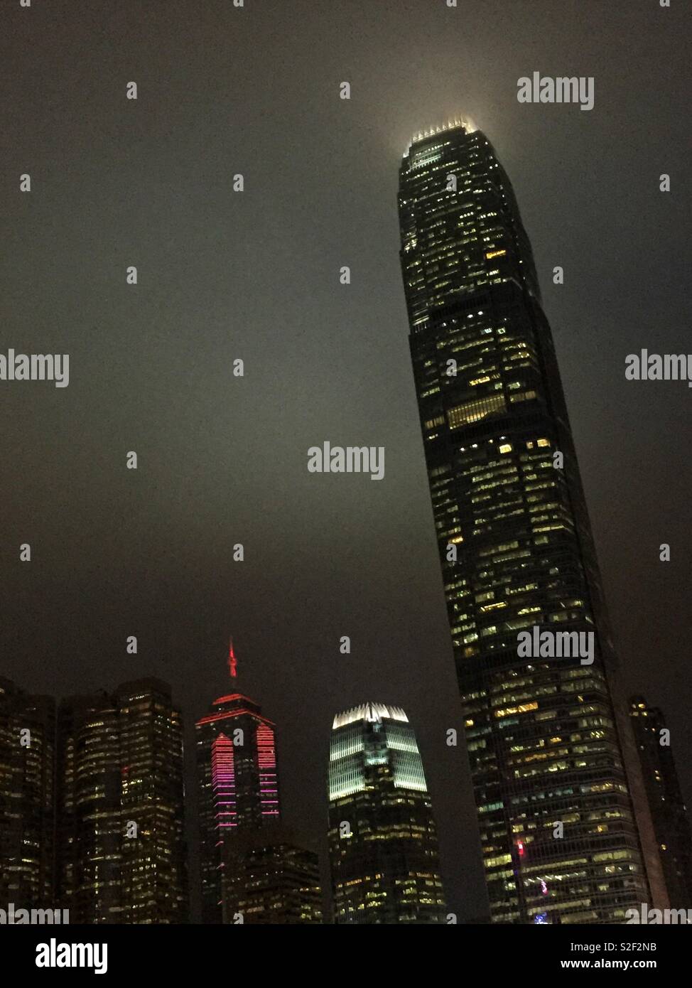 Hong Kong Island commercial skyscapers at night: (l to r) Exchange Square, The Center, 1ifc, and 2ifc, Hong Kong's second tallest - Smartphone Captured Stock Image