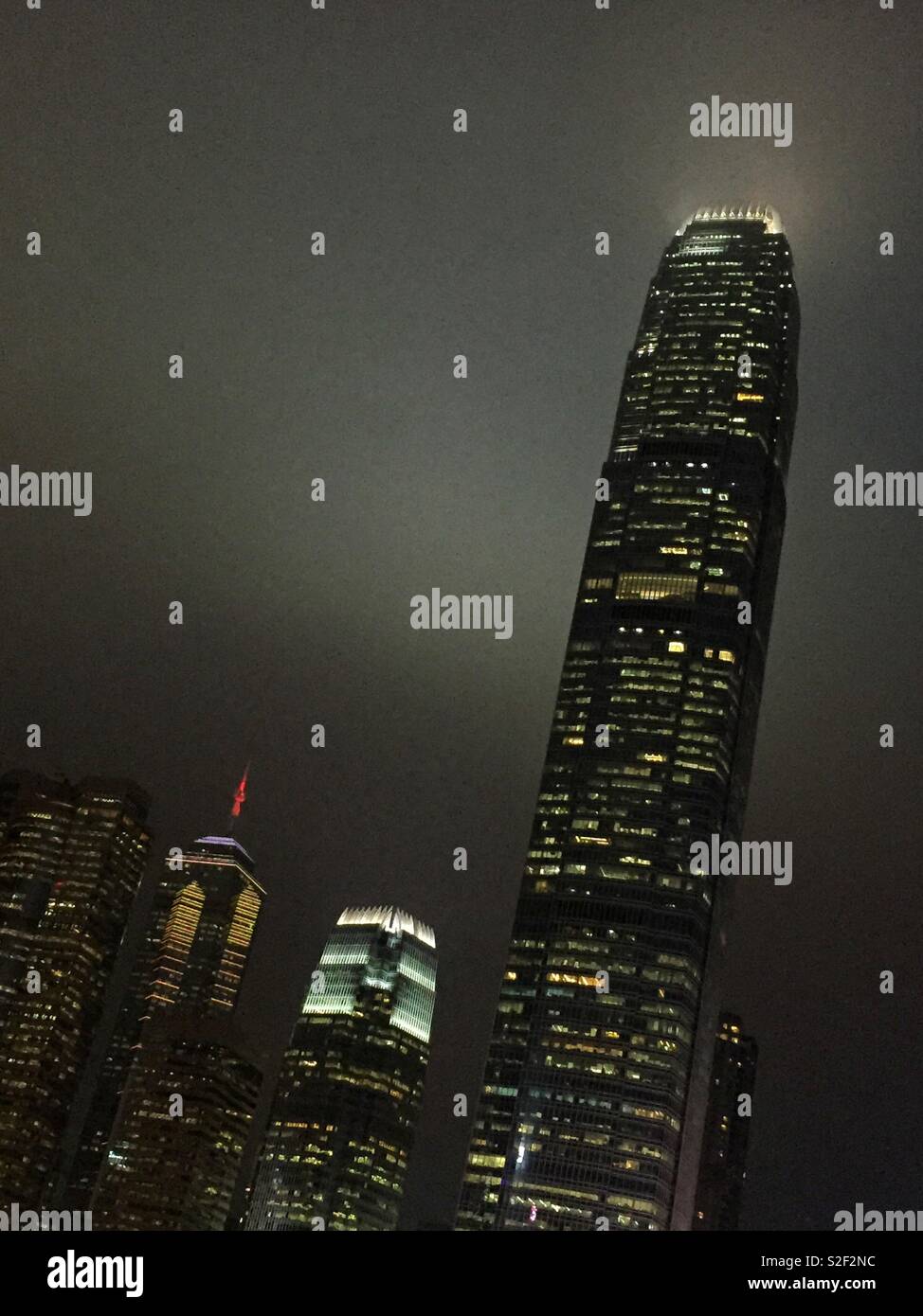 Hong Kong Island commercial skyscapers at night: (l to r) Exchange Square, The Center, 1ifc, and 2ifc, Hong Kong's second tallest - Smartphone Captured Stock Image