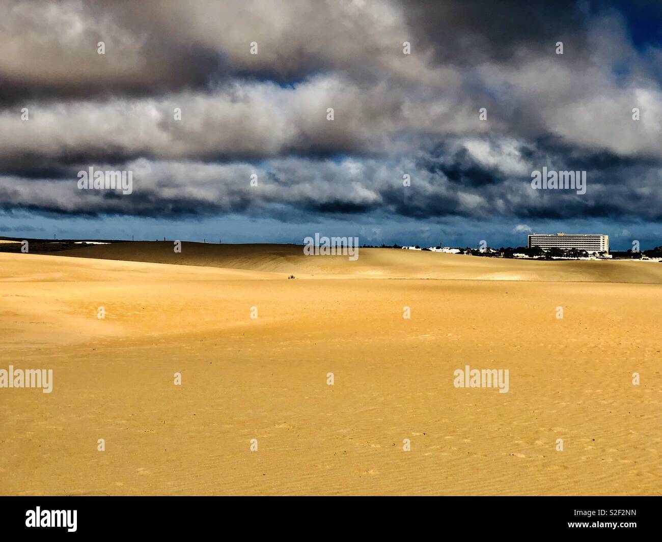 Deep Clouds over the Dunes of the Parque Natural de las Dunas de Corralejo, Beach near Corralejo, in the North of Fuerteventura Island, Canary Islands, Spain, Europe - Smartphone Captured Stock Image