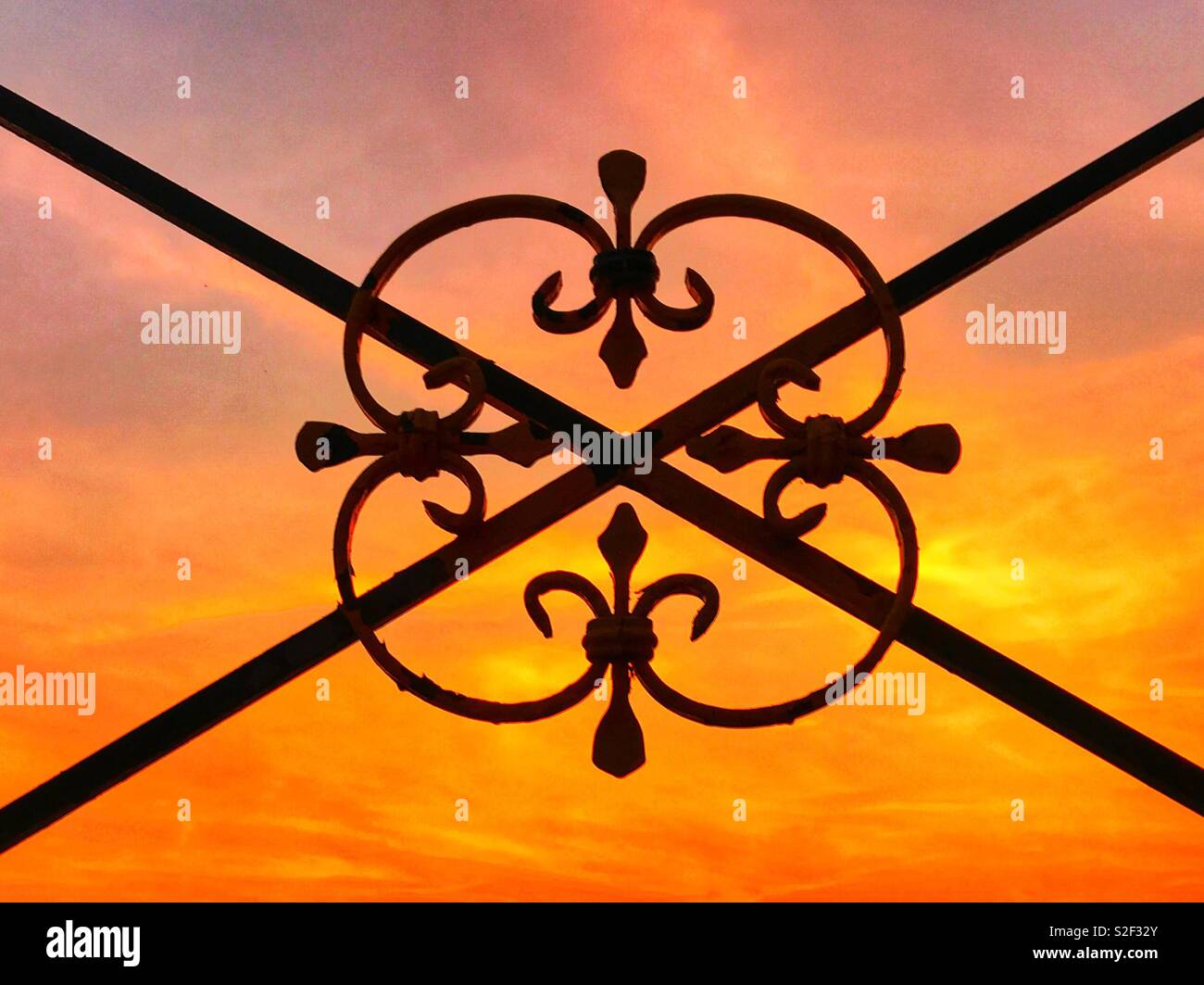 Wrought iron decoration against a sunset sky - Smartphone Captured Stock Image