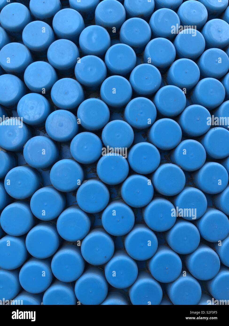 Collage of plastic blue bottle caps Stock Photo