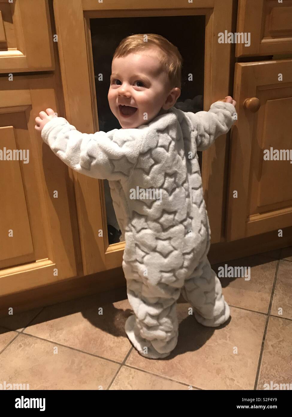 Baby learning to walk Stock Photo