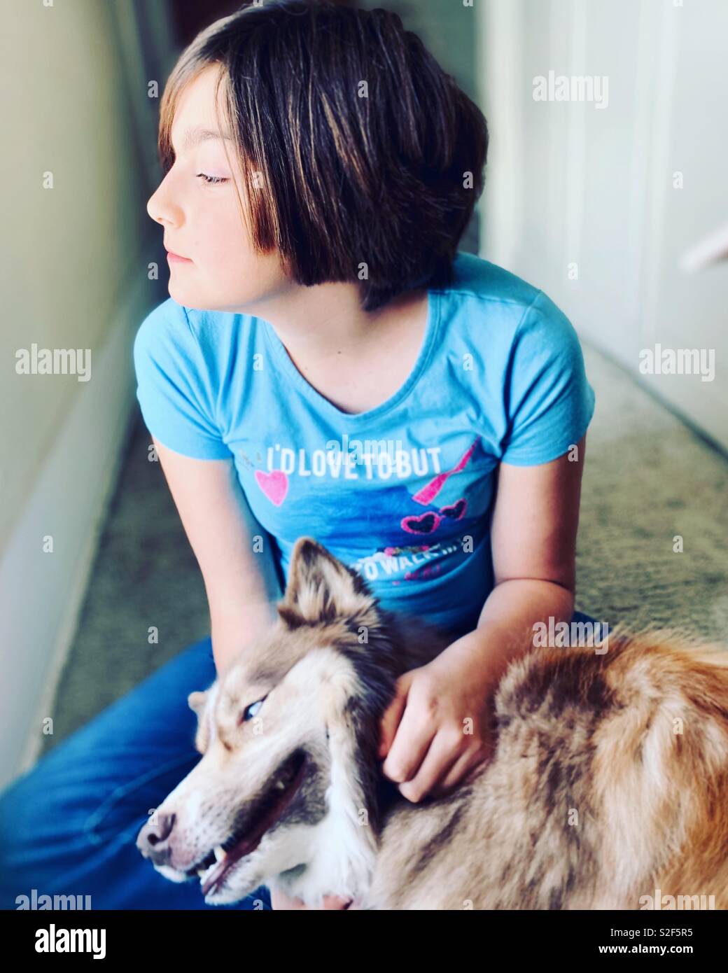 Preteen girl with her dog. - Smartphone Captured Stock Image