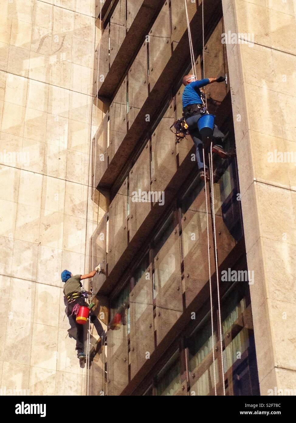 Window washers, acrobatic work - Smartphone Captured Stock Image