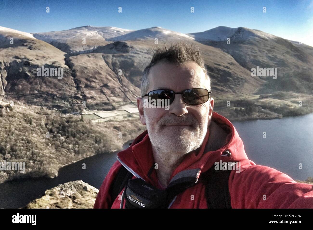 Man in Red Above Lake - Smartphone Captured Stock Image