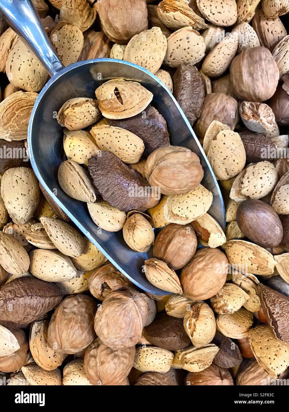 Mixed raw nuts with metal scoop - Smartphone Captured Stock Image