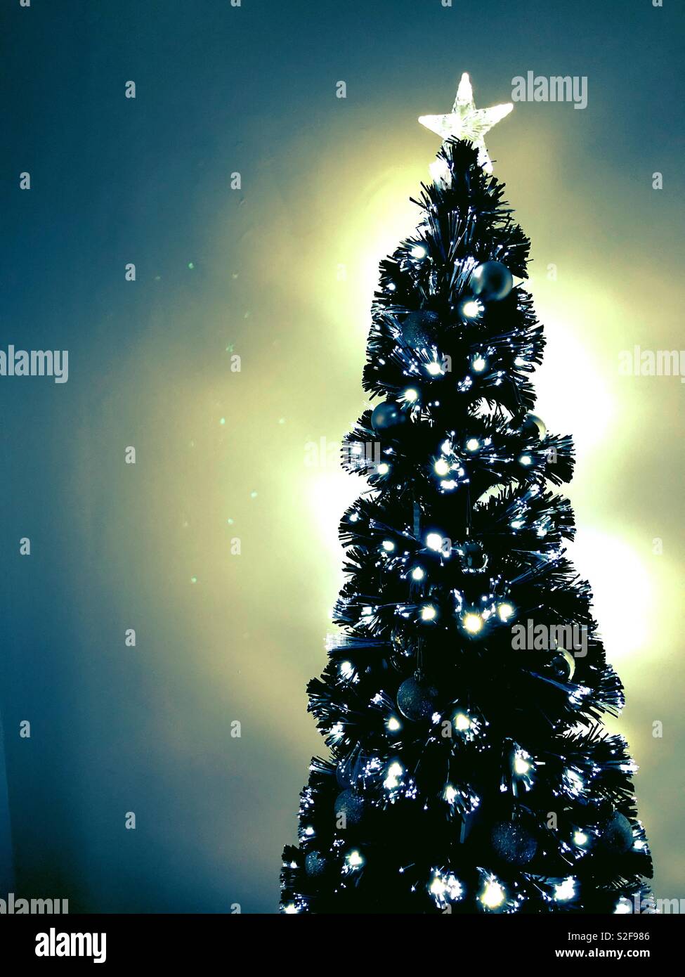 Glowing Black Christmas tree with silver decorations - Smartphone Captured Stock Image