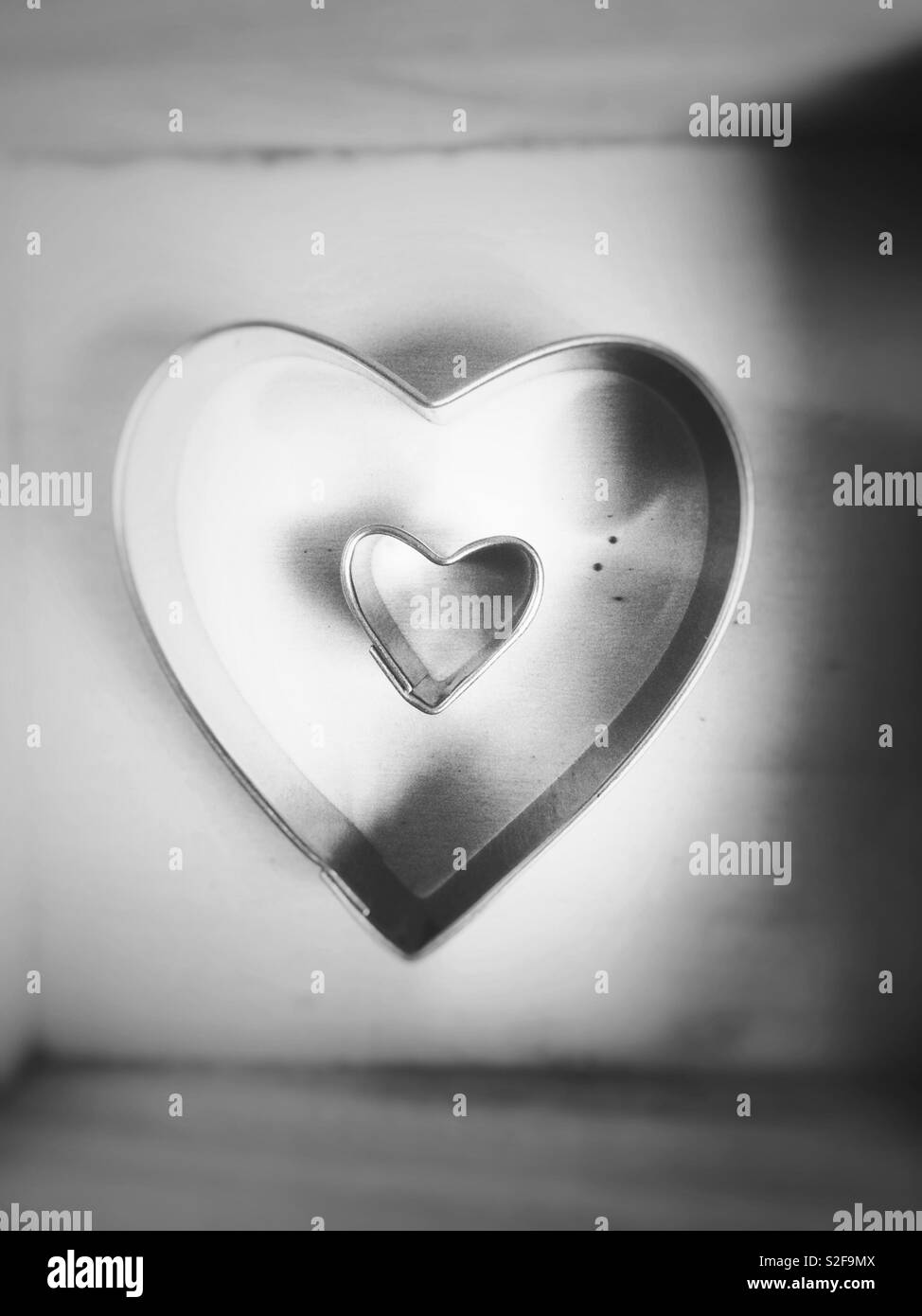 Two metallic hearts shape inside box. Love concept - Smartphone Captured Stock Image