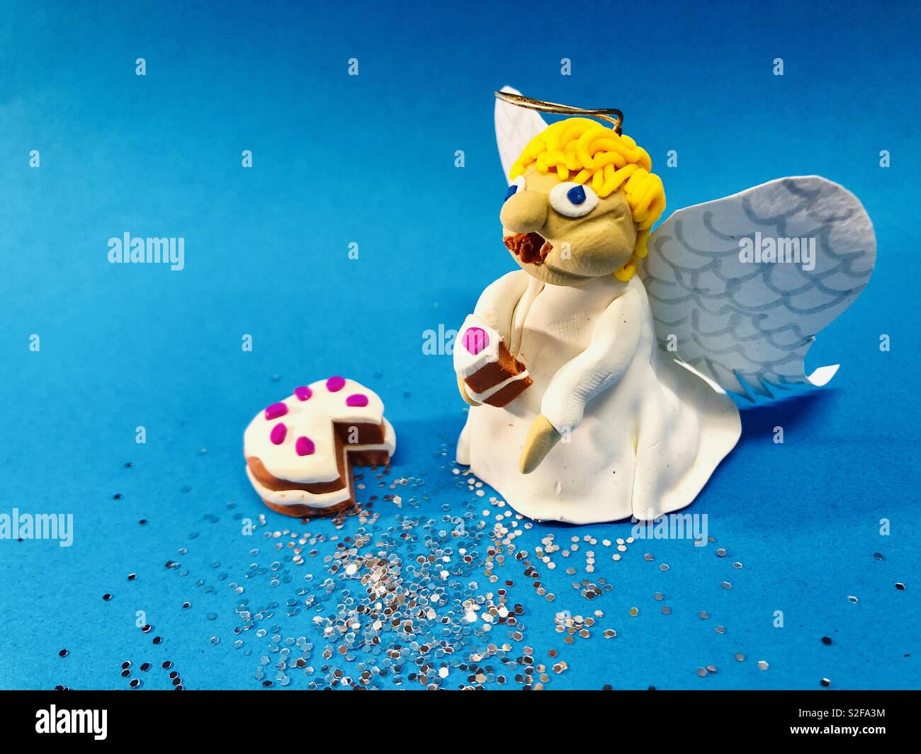 Angel eating cake Stock Photo Alamy