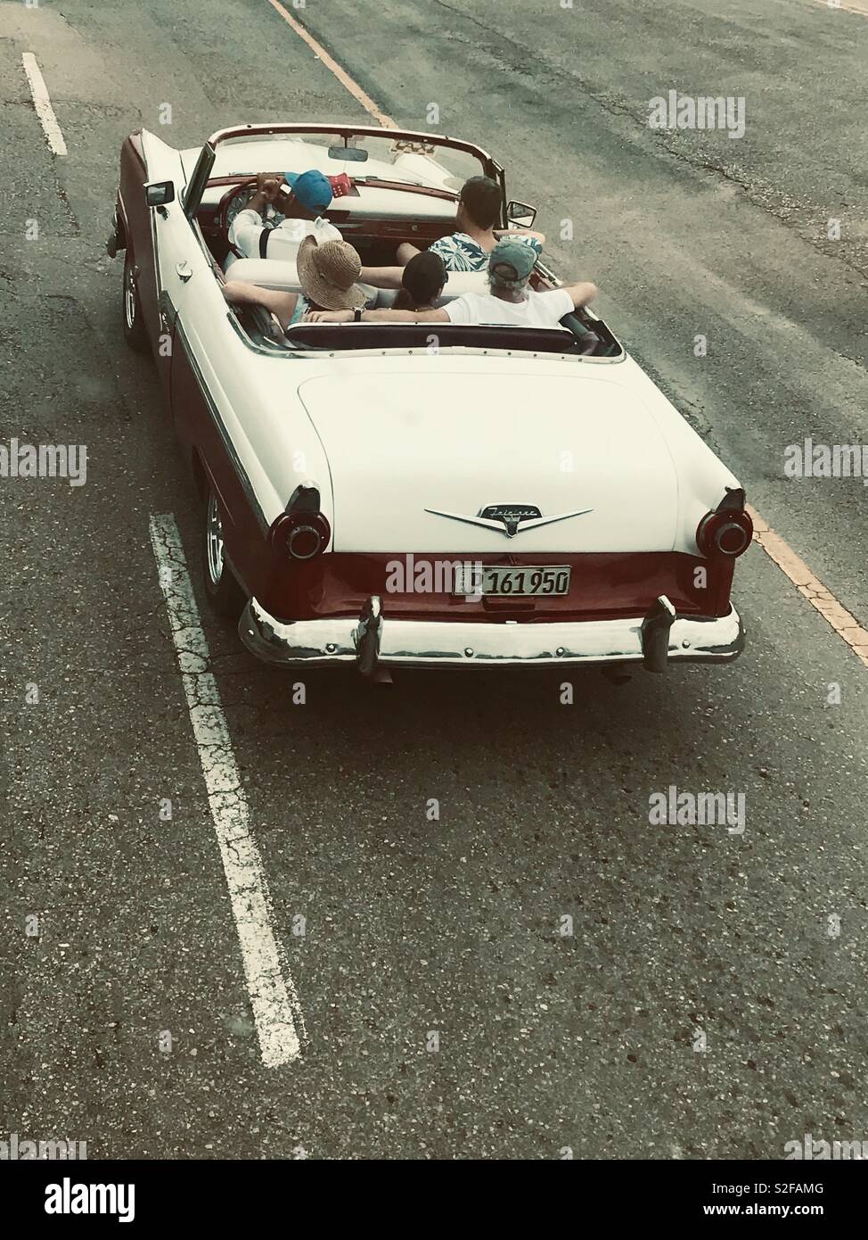 People cruising around in a classic convertible car in Havana Cuba Stock Photo