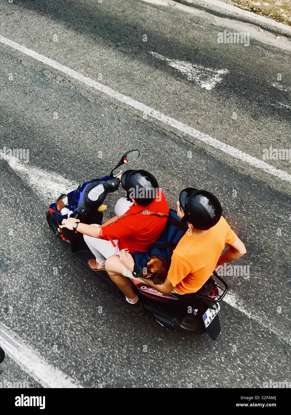Two people riding a motorbike in the streets of Havana Cuba Stock Photo