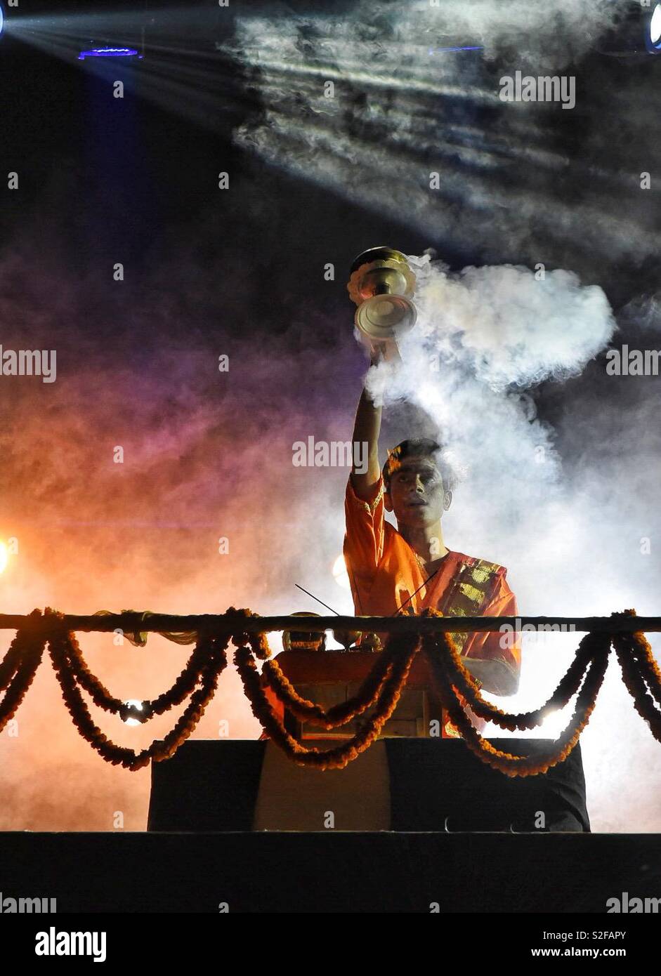 Magical moment at the Ganga Aarti at Varanasi, India. Evening Aarti is being conducted daily at the ghats in Varanasi to offer prayer to the holy river- Ganga. Stock Photo