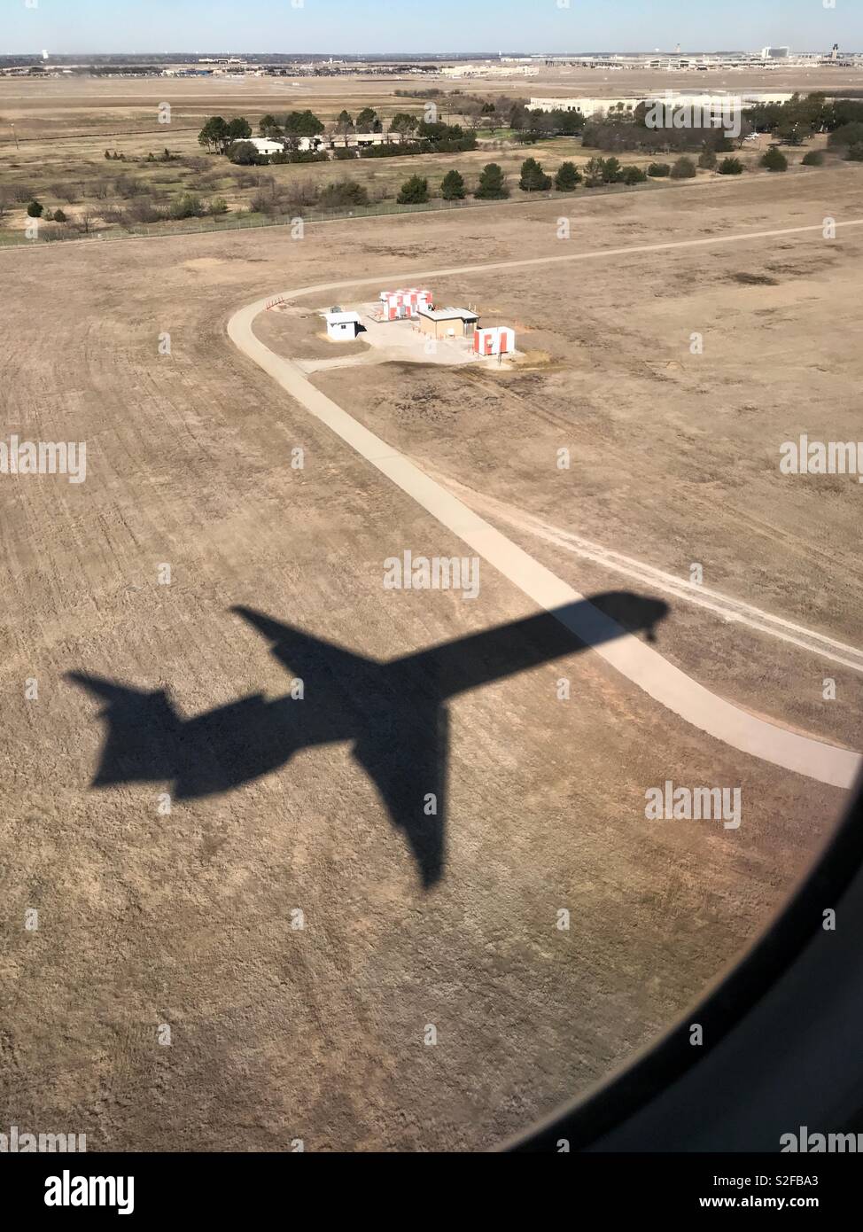 A shadow of the plane I’m in, landing at Dallas/Fort Worth International Airport Stock Photo