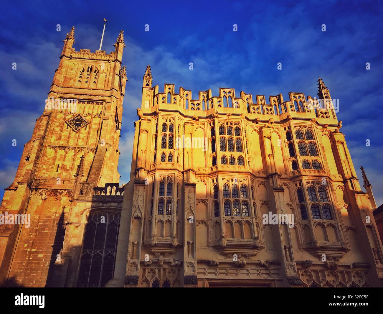 A view of the Bell Tower and Ancient Town Hall that form the exterior view of St. John Baptist Church in the Roman City of Cirencester, Gloucestershire, England. Photo Credit - © COLIN HOSKINS. Stock Photo