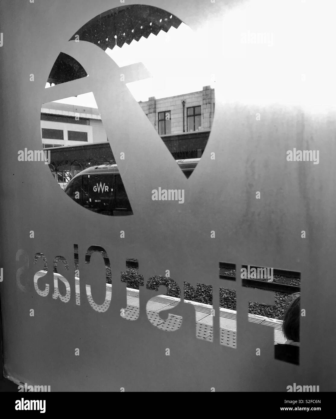 GWR inter-city train seen through the frosted glass window of the First Class lounge at Cardiff Central Station. Stock Photo