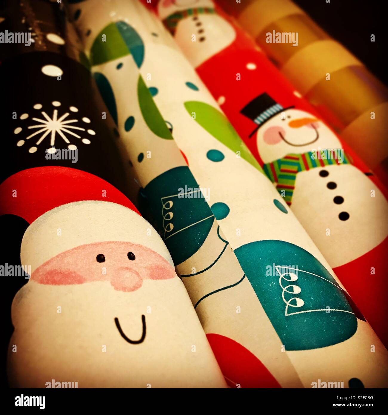 Many colorful rolls of holiday gift wrapping paper Stock Photo