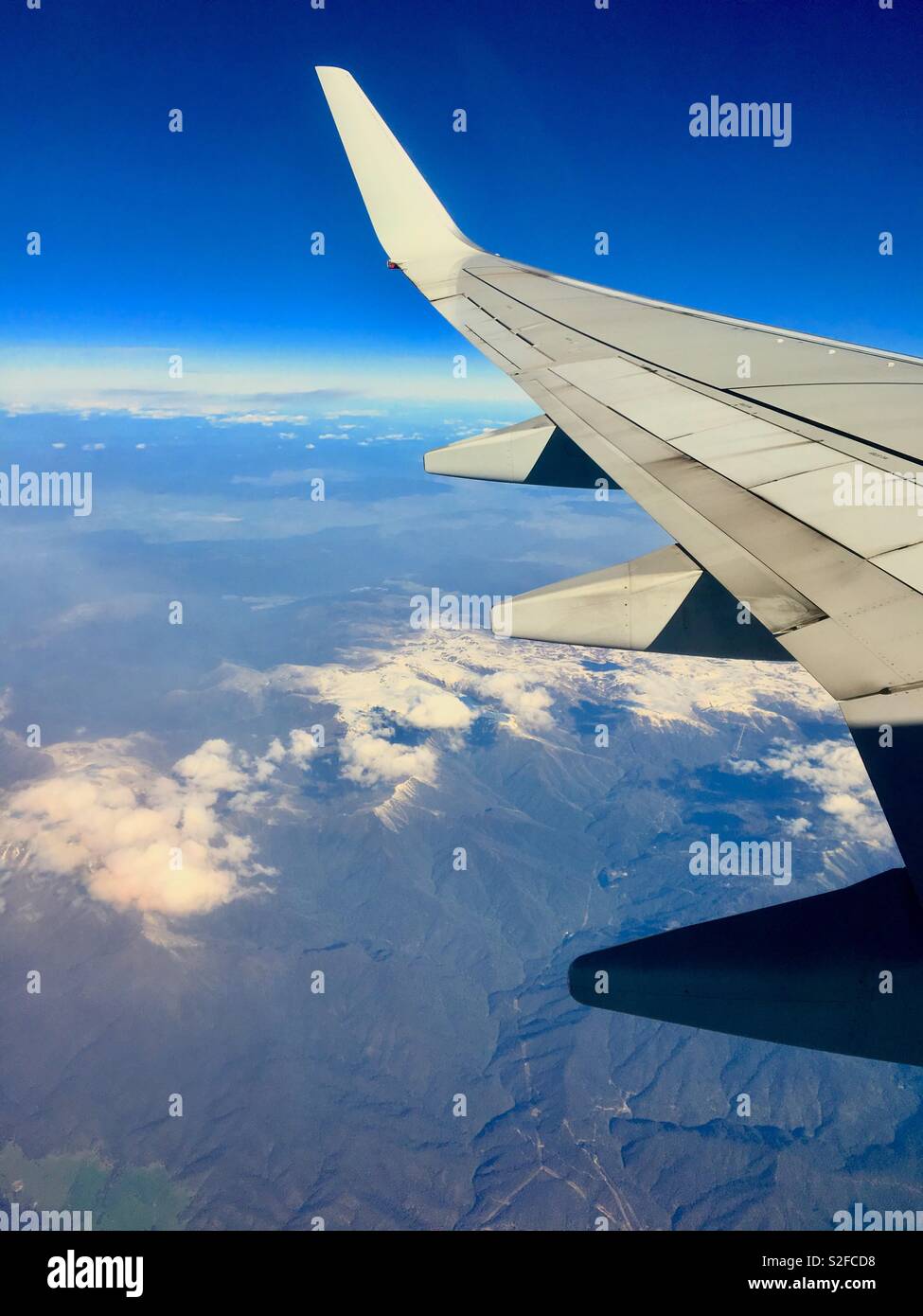 View of snowy mountains in Australia from aeroplane window - Smartphone Captured Stock Image