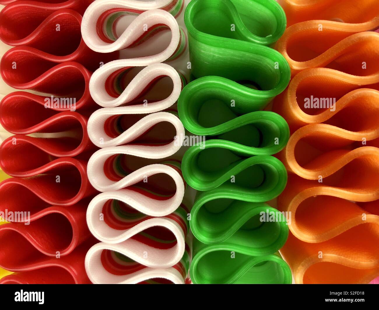 Brightly colored ribbon candy on a white background - Smartphone Captured Stock Image