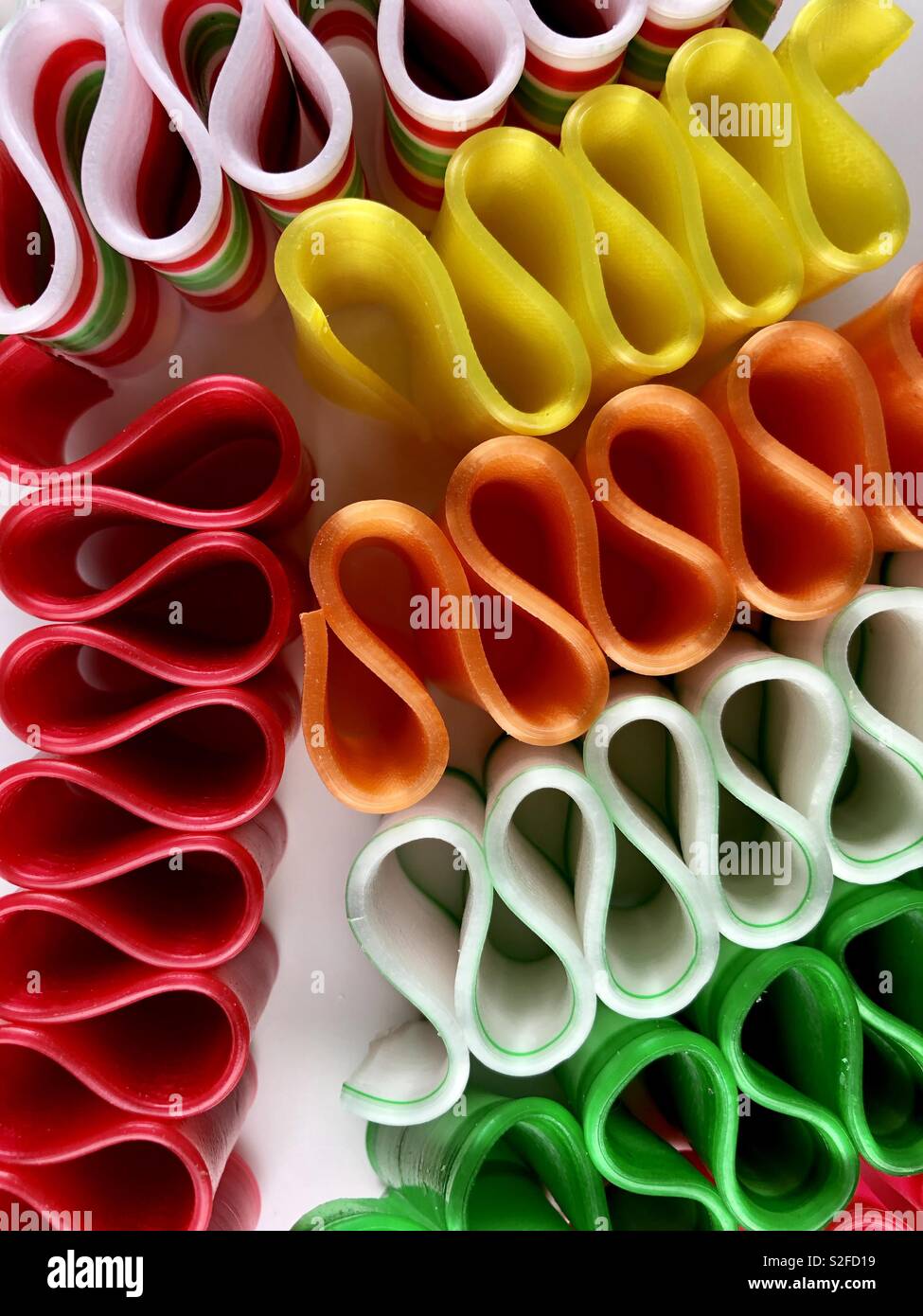 Brightly colored ribbon candy on a white background Stock Photo