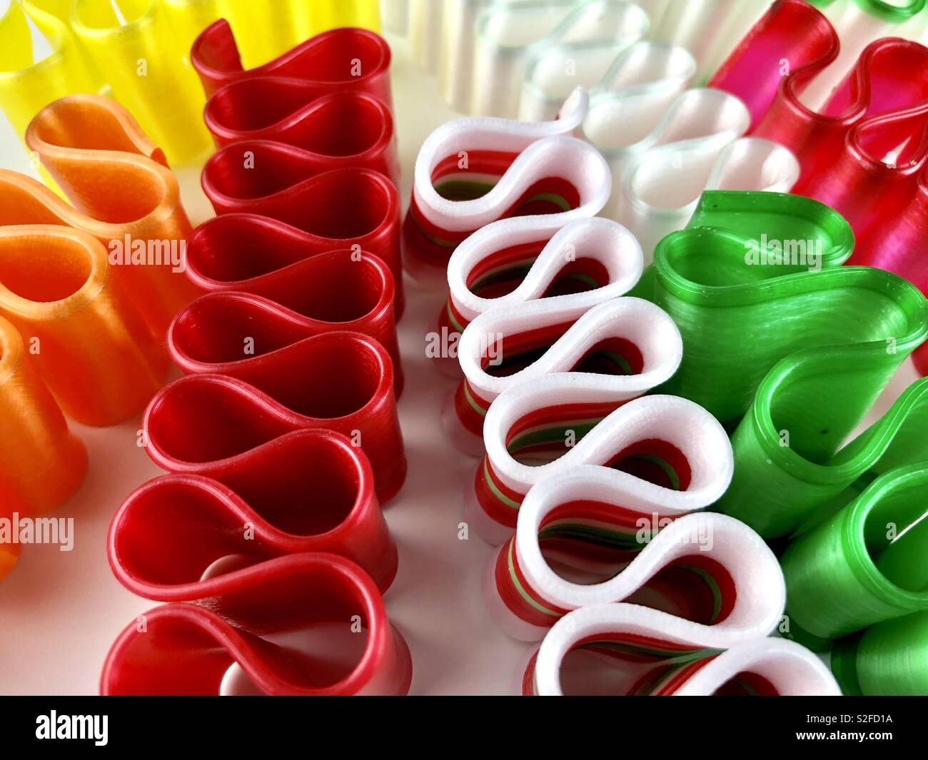 Brightly colored ribbon candy on a white background Stock Photo
