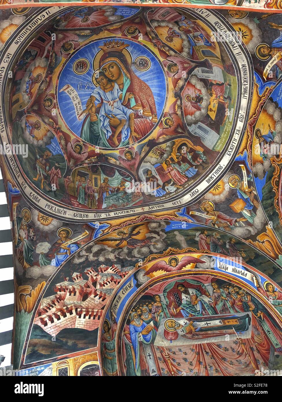 Colourful iconic frescoes on the walls and ceilings of the Rila Monastery, a UNESCO World Heritage Site in Bulgaria. - Smartphone Captured Stock Image