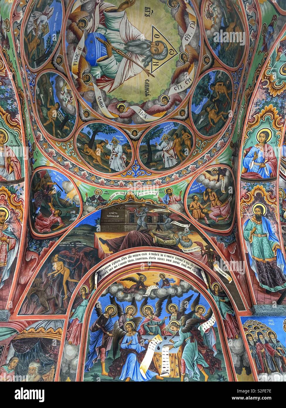Colourful iconic frescoes painted on the walls and ceilings of the Rila Monastery, a UNESCO World Heritage Site in Bulgaria. - Smartphone Captured Stock Image