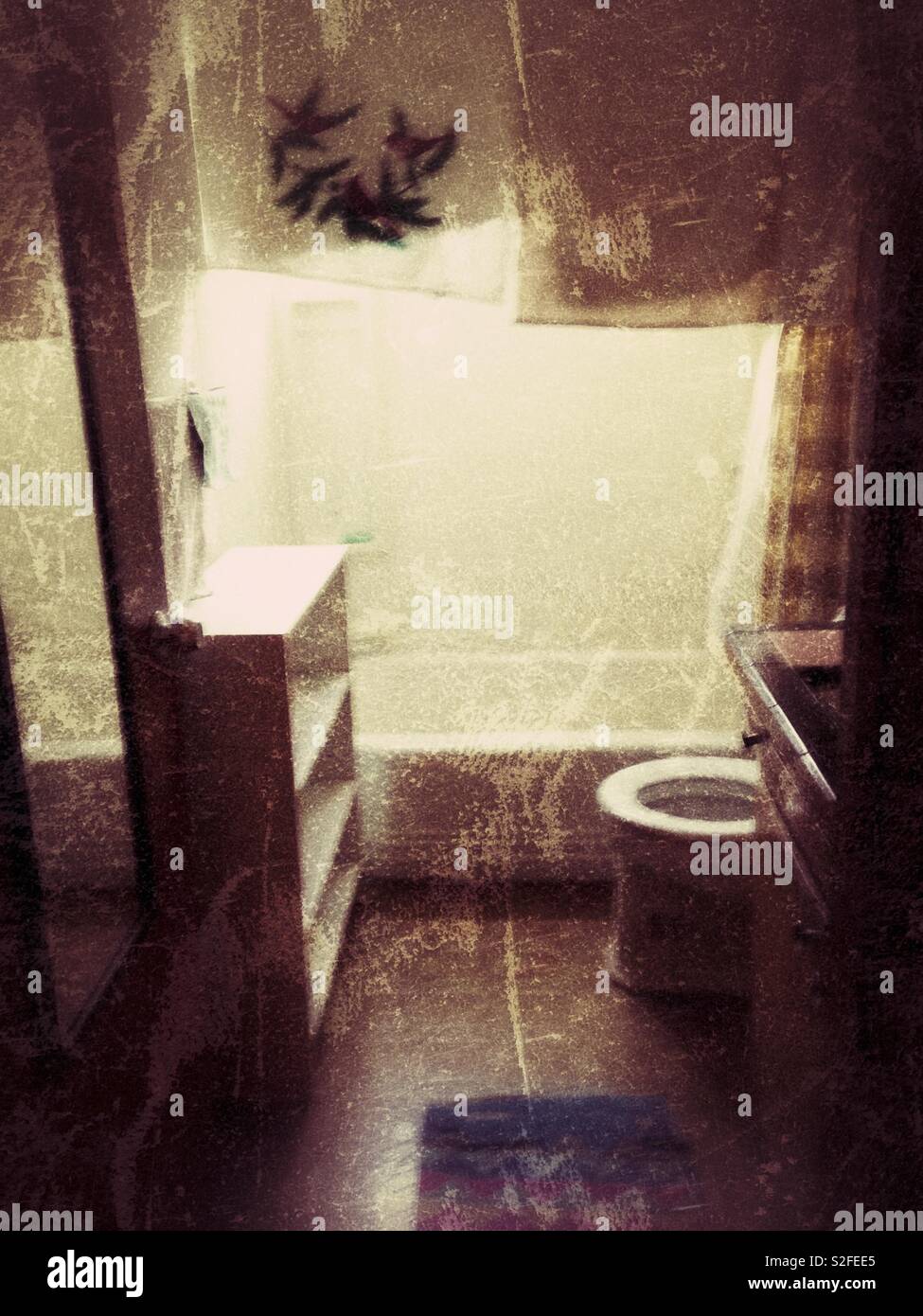 Grunge photo of tiny empty apartment bathroom with window light - Smartphone Captured Stock Image