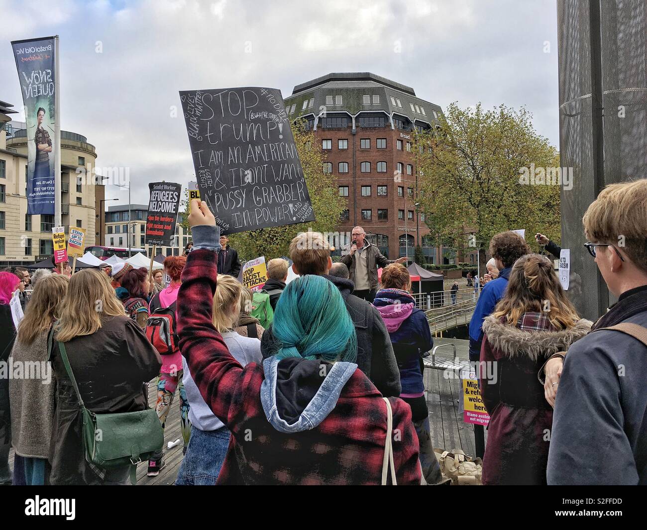 A woman holds a placard aloft at a demonstration against the election of Donald Trump as US president in Bristol, UK on 12 November 2016 - Smartphone Captured Stock Image