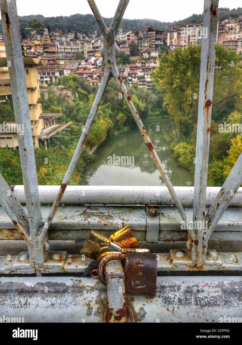 Rusty love locks on a bridge in the medieval town, Veliko Tornovo in Bulgaria. - Smartphone Captured Stock Image