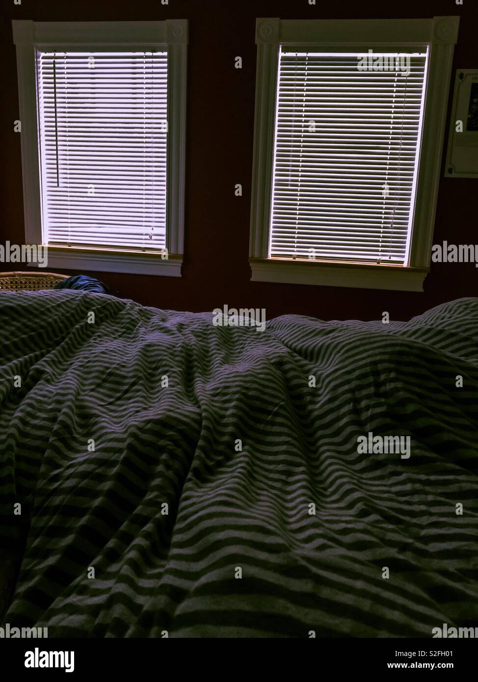 Bed with two windows Stock Photo Alamy